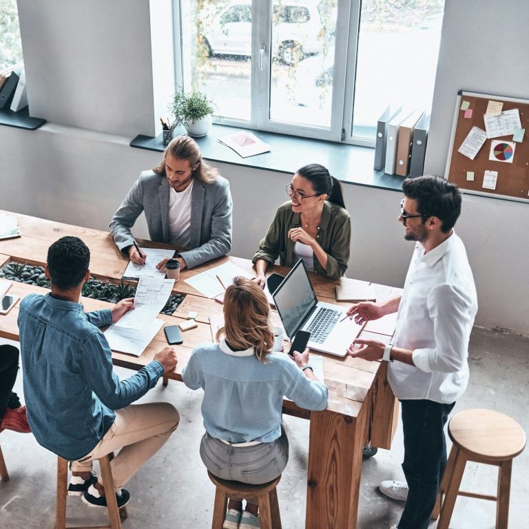 A group of professionals sat at a table having a discussion